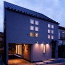 （西東京市）ひばりが丘の木造３階建ての家の写真 外観夕景、ガレージが庭へとつながっています