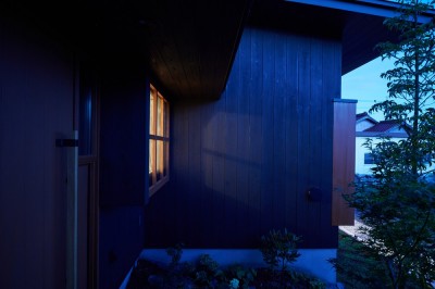 ダイニング出窓からの灯り (田園のガレージハウス／焼杉板と片流れ屋根の連なる家)