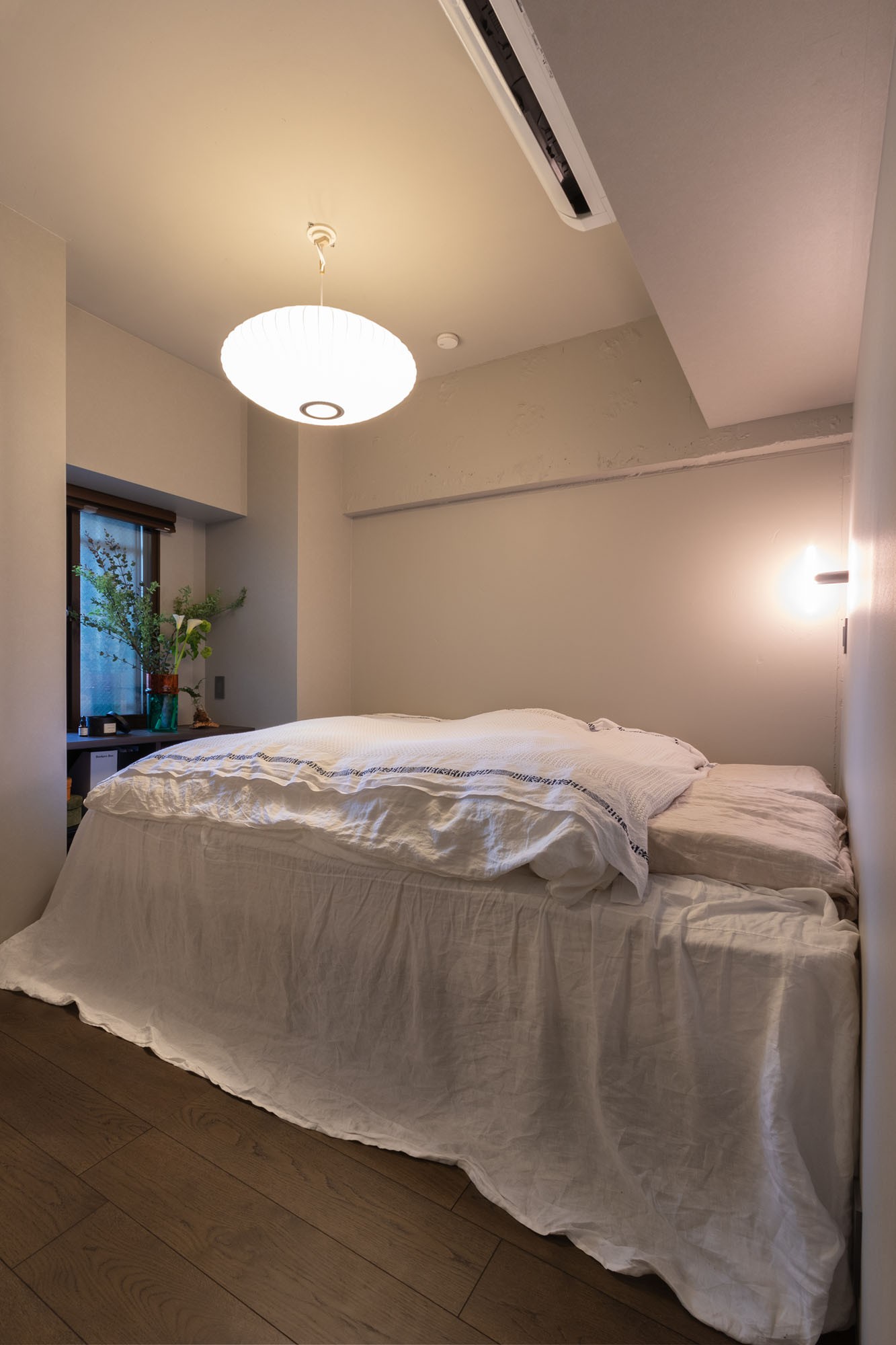 ベッドルーム事例：寝室の床にはA邸唯一のフローリングを採用。バブルランプの優美なシルエットがまるでホテルのようなベッドルームを演出。（家具とイエ、両方が引き立つ家づくり）