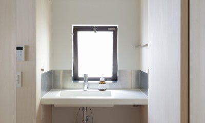 登美ヶ丘のマンションリフォーム／ありのままの質感を活かした風通しの良い家 (窓のある洗面台)