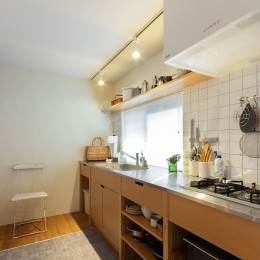 キッチンはこんな奥とに壁付けでレイアウト。見せる収納に厳選した食器と調理器具が並ぶ。 (ピットリビングのある“わたしサイズ”の家)