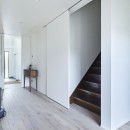 継承した家をたくさんの人が集まりやすいシンプルかつモダンな空間にの写真 階段の引き戸