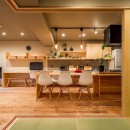 アイランドキッチンと広々ＬＤＫの 暮らしを愉しむ家の写真 木製オーダーキッチンとつながるダイニングテーブル