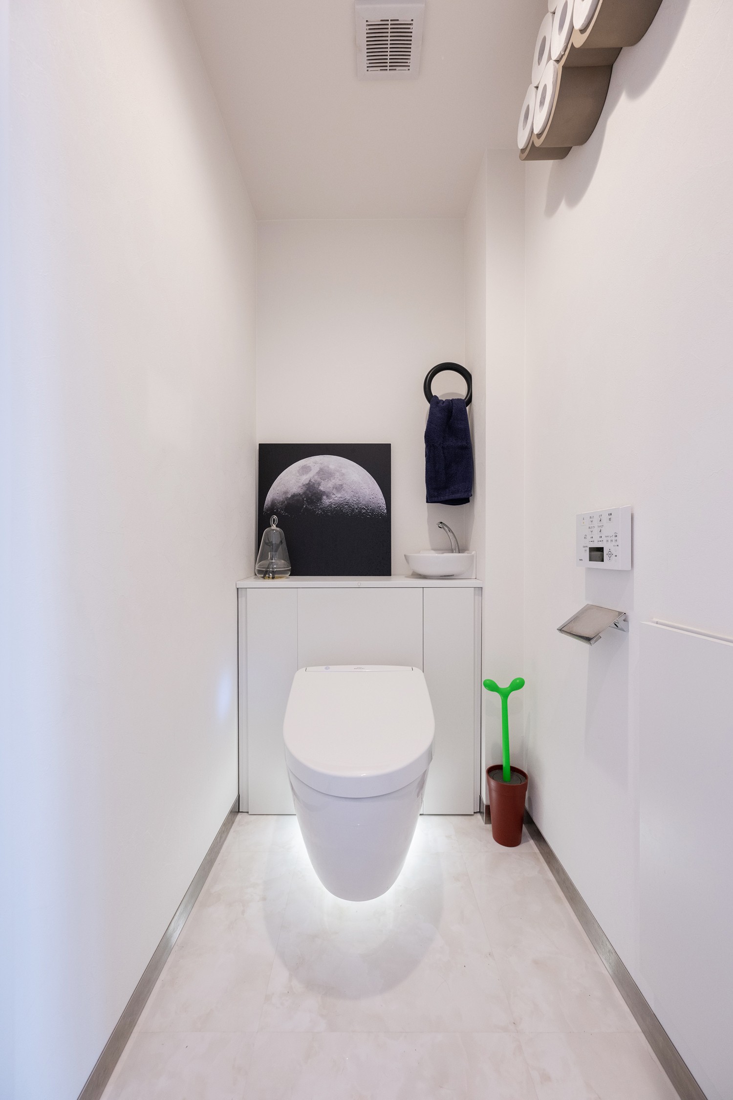 バス/トイレ事例：真っ白なトイレに浮かぶ月の写真のセンスが素敵。照明を使って白を際立たせています（暮らしの背景としての白）