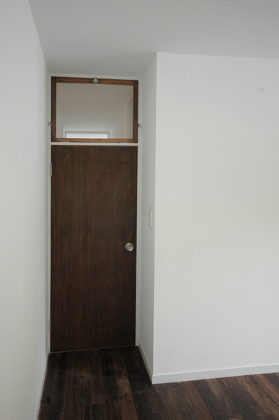 ベッドルーム事例：個室の入口ドア（木々の中に浮かぶ大きなバルコニー）